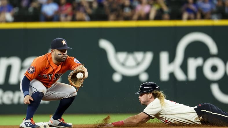 Jul 1, 2023; Arlington, Texas, USA; Texas Rangers left fielder Travis Jankowski (16) steals second base ahead of the tag by Houston Astros second baseman Jose Altuve (27) during the fourth inning at Globe Life Field. Mandatory Credit: Kevin Jairaj-USA TODAY Sports