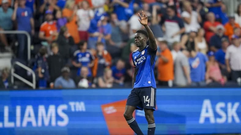 Jul 1, 2023; Cincinnati, Ohio, USA; FC Cincinnati forward Dominique Badji (14) celebrates after scoring a goal against the New England Revolution in the second half at TQL Stadium. Mandatory Credit: Aaron Doster-USA TODAY Sports