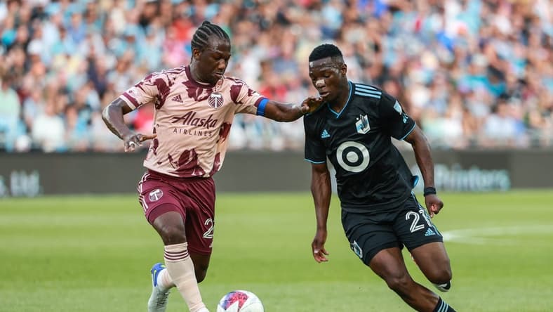 July 1, 2023; Saint Paul, Minnesota, USA; Portland Timbers midfielder Diego Char (21) and Minnesota United forward Bongokuhle Hlongwane (21) battle for the ball during the first half at Allianz Field. Mandatory Credit: Matt Krohn-USA TODAY Sports