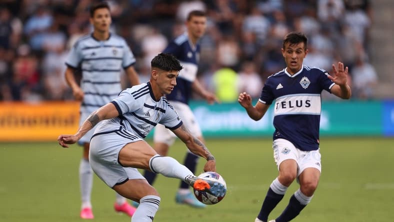 Jul 1, 2023; Kansas City, Kansas, USA; Sporting Kansas City forward Alan Pulido (9) controls the ball against Vancouver Whitecaps midfielder Andres Cubas (20) during the first half at Children's Mercy Park. Mandatory Credit: William Purnell-USA TODAY Sports