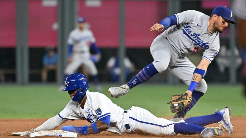Jul 1, 2023; Kansas City, Missouri, USA;  Kansas City Royals right fielder Dairon Blanco (44) steals second base against Los Angeles Dodgers shortstop Miguel Rojas (11) in the seventh inning at Kauffman Stadium. Mandatory Credit: Peter Aiken-USA TODAY Sports