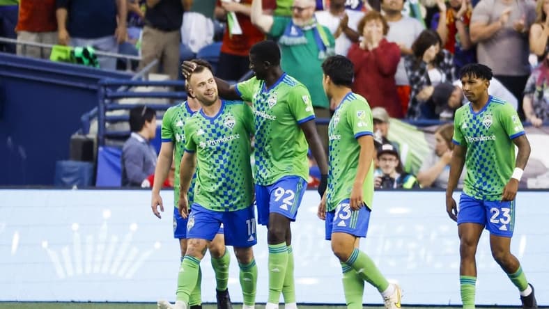 Jul 1, 2023; Seattle, Washington, USA; Seattle Sounders FC midfielder Albert Rusnak (11) celebrates with midfielder defender Abdoulaye Cissoko (92) after scoring a goal against the Houston Dynamo during the second half at Lumen Field. Seattle Sounders FC midfielder Leo Chu (23), right, walking back to midfield, assisted on the goal. Mandatory Credit: Joe Nicholson-USA TODAY Sports