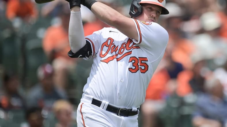Jul 2, 2023; Baltimore, Maryland, USA; Baltimore Orioles catcher Adley Rutschman (35) swings while standing by the on-deck circle during the third inning of the game against the Minnesota Twins at Oriole Park at Camden Yards. Mandatory Credit: Tommy Gilligan-USA TODAY Sports
