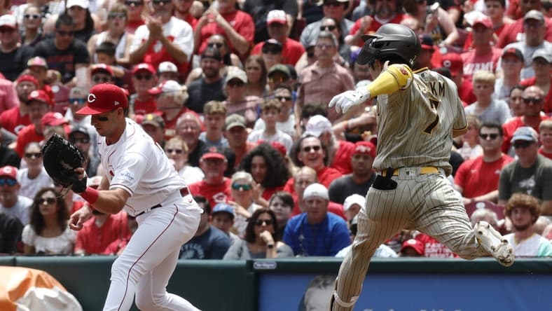 Jul 2, 2023; Cincinnati, Ohio, USA; San Diego Padres second baseman Ha-Seong Kim (7) is out at first against Cincinnati Reds first baseman Spencer Steer (left) during the third inning at Great American Ball Park. Mandatory Credit: David Kohl-USA TODAY Sports