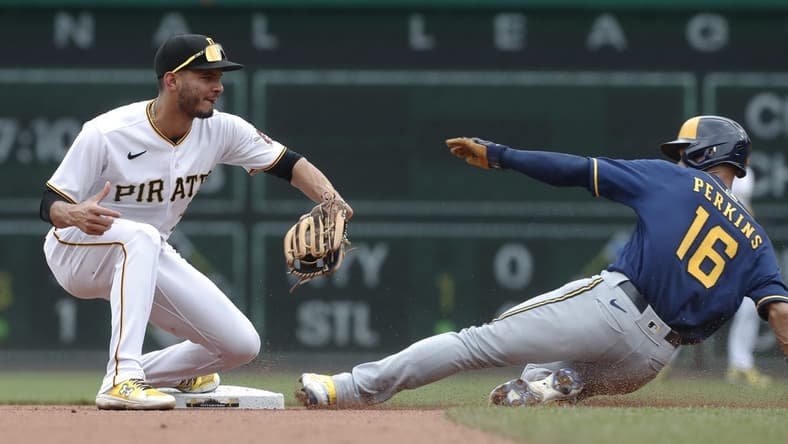 Jul 2, 2023; Pittsburgh, Pennsylvania, USA;  Pittsburgh Pirates shortstop Tucupita Marcano (30) takes a throw to force Milwaukee Brewers left fielder Blake Perkins (16) out at second base during the fourth inning at PNC Park. Mandatory Credit: Charles LeClaire-USA TODAY Sports
