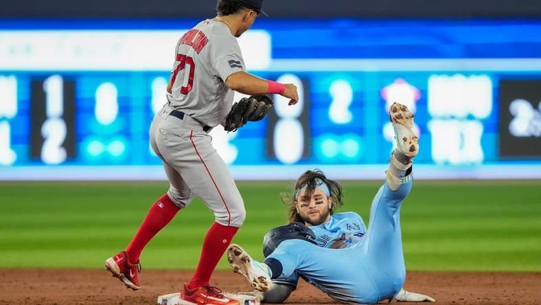 Jul 2, 2023; Toronto, Ontario, CAN; Toronto Blue Jays shortstop Bo Bichette (11) is tagged out at second by Boston Red Sox shortstop David Hamilton (70) during the third inning at Rogers Centre. Mandatory Credit: Kevin Sousa-USA TODAY Sports