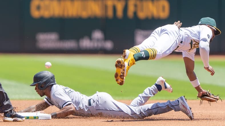 Jul 2, 2023; Oakland, California, USA; Oakland Athletics second baseman Tony Kemp (5) misses the ball against Chicago White Sox shortstop Tim Anderson (7) during the first inning at Oakland-Alameda County Coliseum. Mandatory Credit: Stan Szeto-USA TODAY Sports