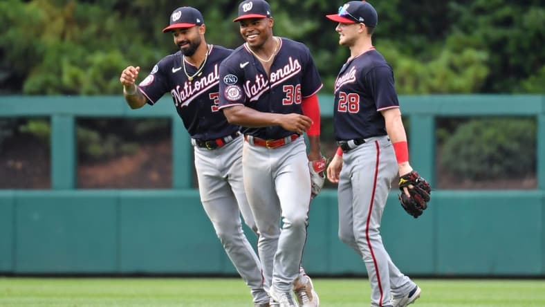 Jul 2, 2023; Philadelphia, Pennsylvania, USA; Washington Nationals center fielder Derek Hill (34), left fielder Stone Garrett (36) and right fielder Lane Thomas (28) celebrate win against the Philadelphia Phillies at Citizens Bank Park. Mandatory Credit: Eric Hartline-USA TODAY Sports