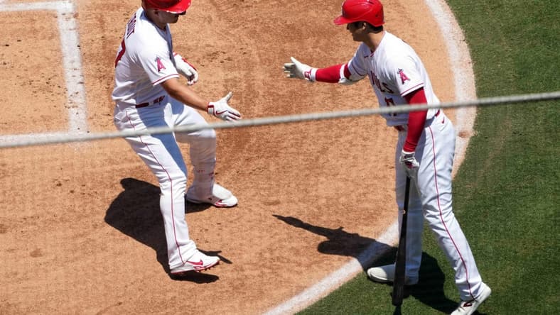 Jul 2, 2023; Anaheim, California, USA; Los Angeles Angels center fielder Mike Trout (27) celebrates with starting pitcher Shohei Ohtani (17) after hitting a solo home run in the first inning against the Arizona Diamondbacks at Angel Stadium. Mandatory Credit: Kirby Lee-USA TODAY Sports