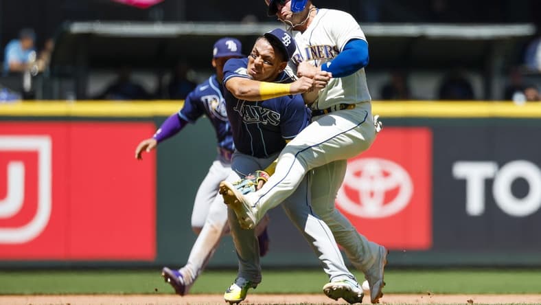 Jul 2, 2023; Seattle, Washington, USA; Tampa Bay Rays third baseman Isaac Paredes (17) collides with Seattle Mariners first baseman Ty France (23) while attempting to field a ground ball during the third inning at T-Mobile Park. Mandatory Credit: Joe Nicholson-USA TODAY Sports