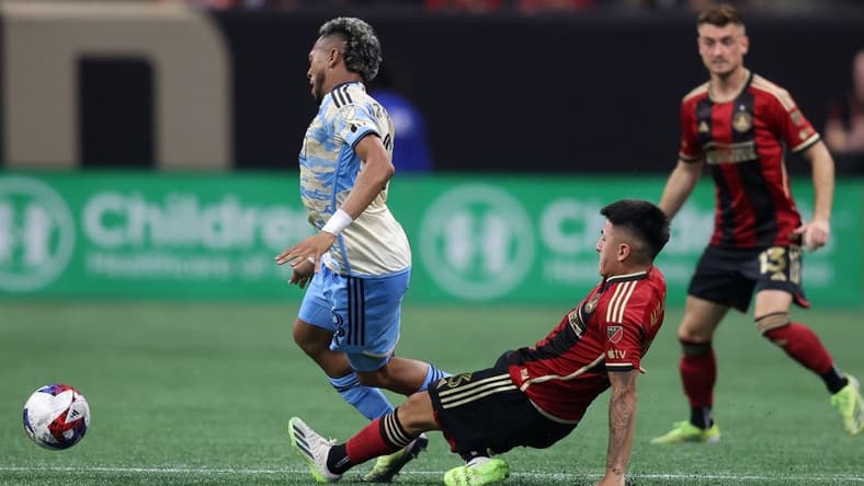 Jul 2, 2023; Atlanta, Georgia, USA; Atlanta United midfielder Thiago Almada (23) slides against Philadelphia Union midfielder Jose Andres Martinez (8) in the second half at Mercedes-Benz Stadium. Mandatory Credit: Brett Davis-USA TODAY Sports