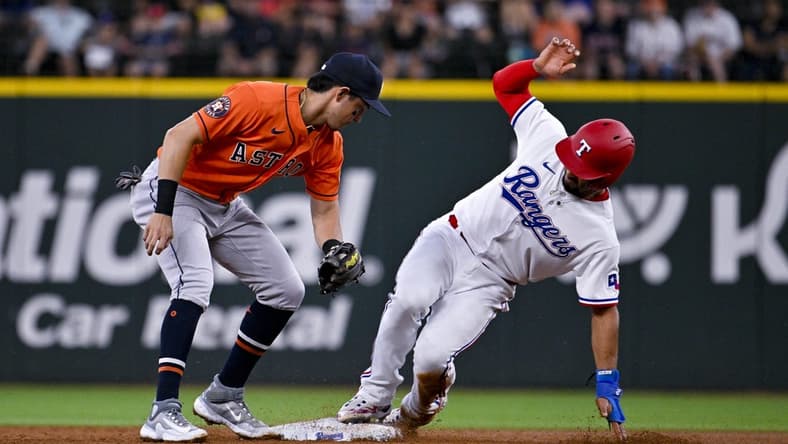 Jul 3, 2023; Arlington, Texas, USA; Texas Rangers second baseman Marcus Semien (2) steals second base against Houston Astros shortstop Mauricio Dubon (14) during the third inning at Globe Life Field. Mandatory Credit: Jerome Miron-USA TODAY Sports