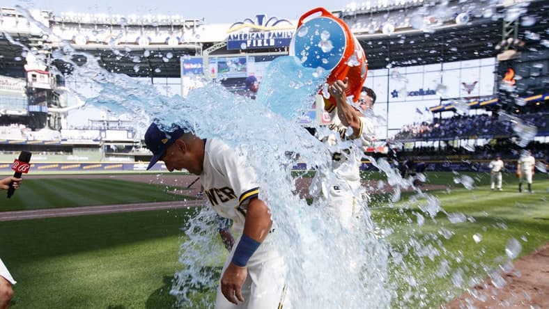 Jul 3, 2023; Milwaukee, Wisconsin, USA;  Milwaukee Brewers Jahmai Jones (12) is dunked with Gatorade by shortstop Willy Adames (27) following the game against the Chicago Cubs at American Family Field. Mandatory Credit: Jeff Hanisch-USA TODAY Sports