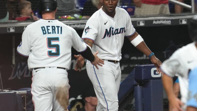 Jul 3, 2023; Miami, Florida, USA; Miami Marlins shortstop Jon Berti (5) is congratulated by designated hitter Jorge Soler (12) after scoring a run in the seventh inning against the St. Louis Cardinals at loanDepot Park. Mandatory Credit: Jim Rassol-USA TODAY Sports