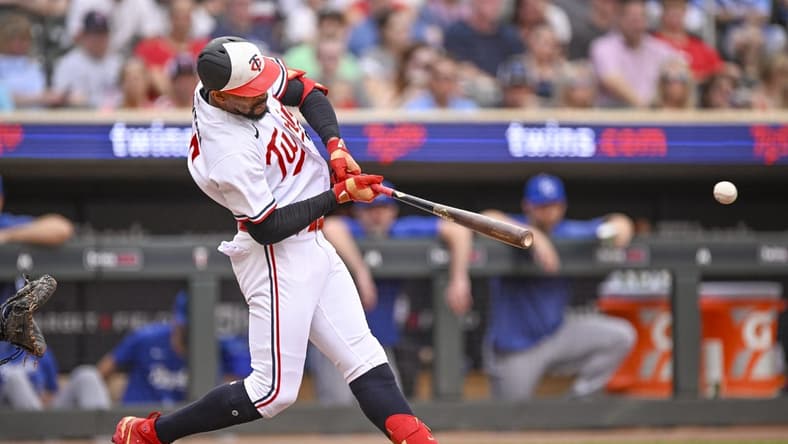 Jul 3, 2023; Minneapolis, Minnesota, USA; Minnesota Twins designated hitter Byron Buxton (25) hits a sacrifice RBI against the Kansas City Royals during the first inning at Target Field. Mandatory Credit: Nick Wosika-USA TODAY Sports