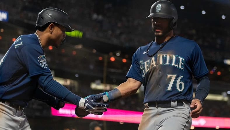Jul 3, 2023; San Francisco, California, USA; Seattle Mariners center fielder Julio Rodriguez (44) celebrates with second baseman Jose Caballero (76) during the ninth inning against the San Francisco Giants at Oracle Park. Mandatory Credit: Stan Szeto-USA TODAY Sports