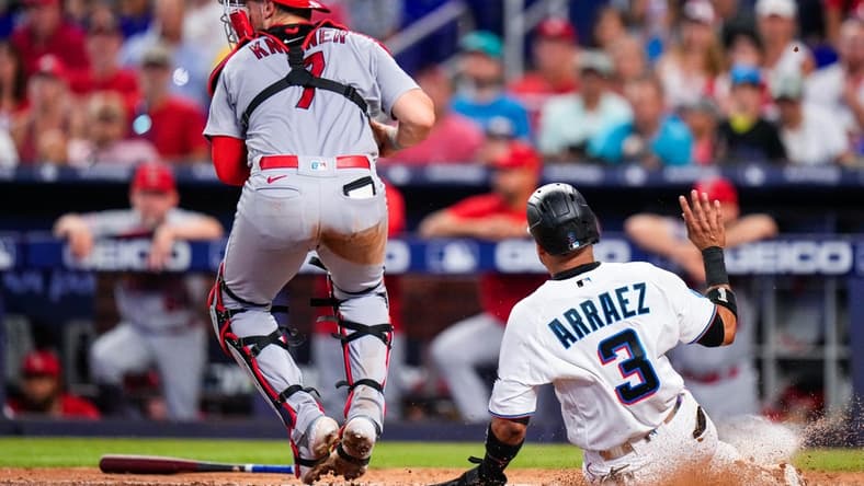 Jul 4, 2023; Miami, Florida, USA; Miami Marlins second baseman Luis Arraez (3) is forced out at home by St. Louis Cardinals catcher Andrew Knizner (7) during the fourth inning at loanDepot Park. Mandatory Credit: Rich Storry-USA TODAY Sports