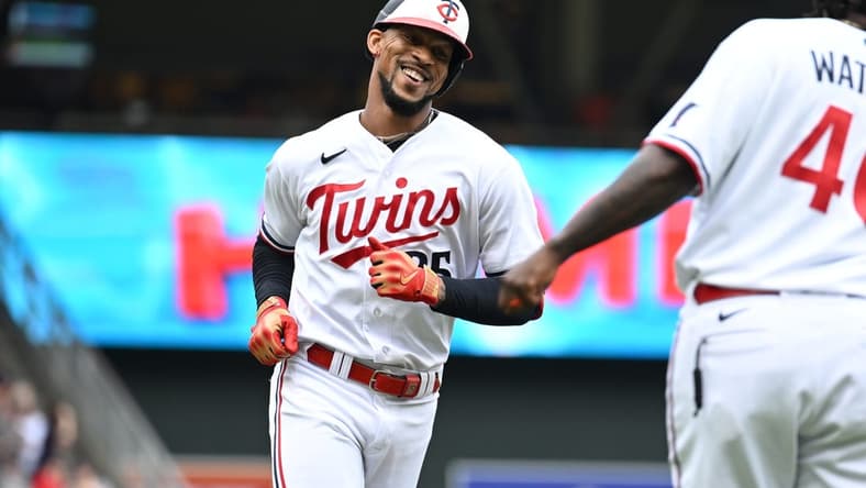 Jul 4, 2023; Minneapolis, Minnesota, USA; Minnesota Twins designated hitter Byron Buxton (25) reacts with third base coach Tommy Watkins (40) after hitting a home run off Kansas City Royals starting pitcher Zack Greinke (not pictured) during the fifth inning at Target Field. Mandatory Credit: Jeffrey Becker-USA TODAY Sports
