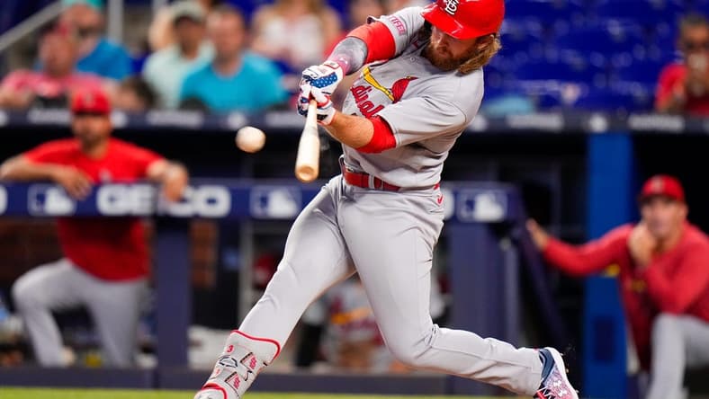 Jul 4, 2023; Miami, Florida, USA; St. Louis Cardinals second baseman Brendan Donovan (33) hits a single against the Miami Marlins during the ninth inning at loanDepot Park. Mandatory Credit: Rich Storry-USA TODAY Sports