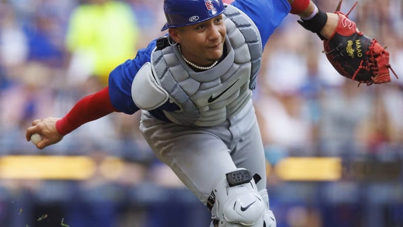 Jul 4, 2023; Milwaukee, Wisconsin, USA; Chicago Cubs catcher Miguel Amaya (6) underhands the ball towards first base during the sixth inning against the Milwaukee Brewers at American Family Field. Mandatory Credit: Jeff Hanisch-USA TODAY Sports