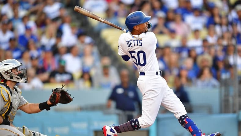 July 4, 2023; Los Angeles, California, USA; Los Angeles Dodgers second baseman Mookie Betts (50) hits a solo home run against the Pittsburgh Pirates during the second inning at Dodger Stadium. Mandatory Credit: Gary A. Vasquez-USA TODAY Sports