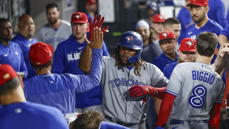 Jul 4, 2023; Chicago, Illinois, USA; Toronto Blue Jays first baseman Vladimir Guerrero Jr. (27) celebrates with teammates after hitting a two-run home run against the Chicago White Sox during the eighth inning at Guaranteed Rate Field. Mandatory Credit: Kamil Krzaczynski-USA TODAY Sports