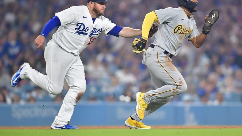 July 4, 2023; Los Angeles, California, USA; Pittsburgh Pirates right fielder Josh Palacios (54) is tagged out on a rundown by Los Angeles Dodgers third baseman Max Muncy (13) during the ninth inning at Dodger Stadium. Mandatory Credit: Gary A. Vasquez-USA TODAY Sports