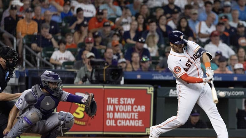 Jul 5, 2023; Houston, Texas, USA; Houston Astros catcher Yainer Diaz (21) hits a two run home run against the Colorado Rockies in the fourth inning at Minute Maid Park. Mandatory Credit: Thomas Shea-USA TODAY Sports