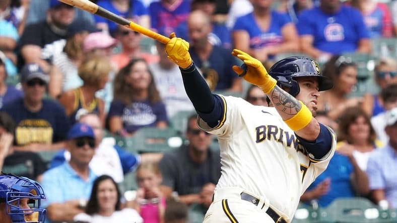 Jul 6, 2023; Milwaukee, Wisconsin, USA; Milwaukee Brewers catcher Victor Caratini (7) hits a home run during the bottom of the eighth inning against the Chicago Cubs at American Family Field. Mandatory Credit: Kayla Wolf-USA TODAY Sports