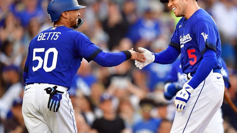 Jul 6, 2023; Los Angeles, California, USA; Los Angeles Dodgers first baseman Freddie Freeman (5) is greeted by second baseman Mookie Betts (50) after hitting a two run home run against the Pittsburgh Pirates during the first inning at Dodger Stadium. Mandatory Credit: Gary A. Vasquez-USA TODAY Sports