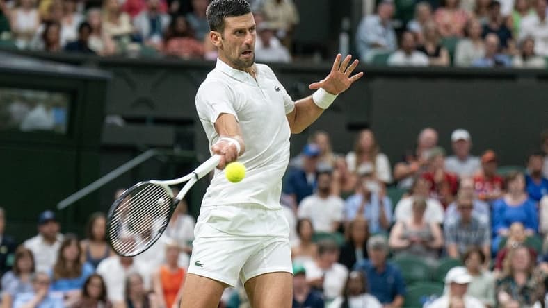 Jul 7, 2023; London, United Kingdom; Novak Djokovic (SRB) returns a shot during his match against Stanislas Wawrinka (SUI) on day five of Wimbledon at the All England Lawn Tennis and Croquet Club. Mandatory Credit: Susan Mullane-USA TODAY Sports