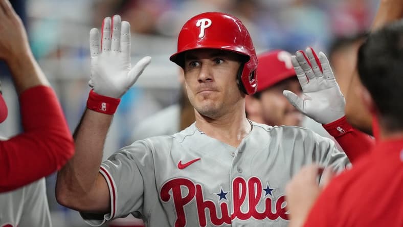 Jul 7, 2023; Miami, Florida, USA; Philadelphia Phillies catcher J.T. Realmuto (10) celebrates in the dugout after hitting a home run in the sixth inning against the Miami Marlins at loanDepot Park. Mandatory Credit: Jim Rassol-USA TODAY Sports