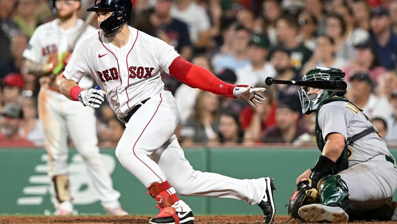 Jul 7, 2023; Boston, Massachusetts, USA; Boston Red Sox center fielder Adam Duvall (18) hits a RBI single against the Oakland Athletics during the seventh inning at Fenway Park. Mandatory Credit: Brian Fluharty-USA TODAY Sports
