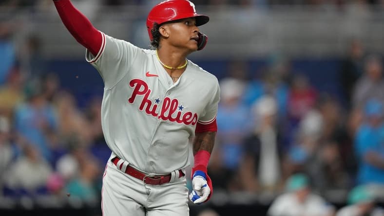 Jul 7, 2023; Miami, Florida, USA; Philadelphia Phillies left fielder Cristian Pache (19) watches his two-run home run clear the wall in the ninth inning against the Miami Marlins at loanDepot Park. Mandatory Credit: Jim Rassol-USA TODAY Sports