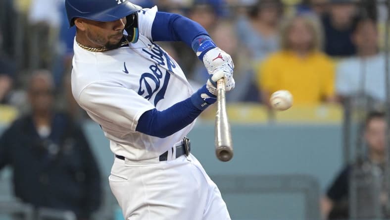Jul 7, 2023; Los Angeles, California, USA; Los Angeles Dodgers right fielder Mookie Betts (50) hits a solo home run in the third inning against the Los Angeles Angels at Dodger Stadium. Mandatory Credit: Jayne Kamin-Oncea-USA TODAY Sports