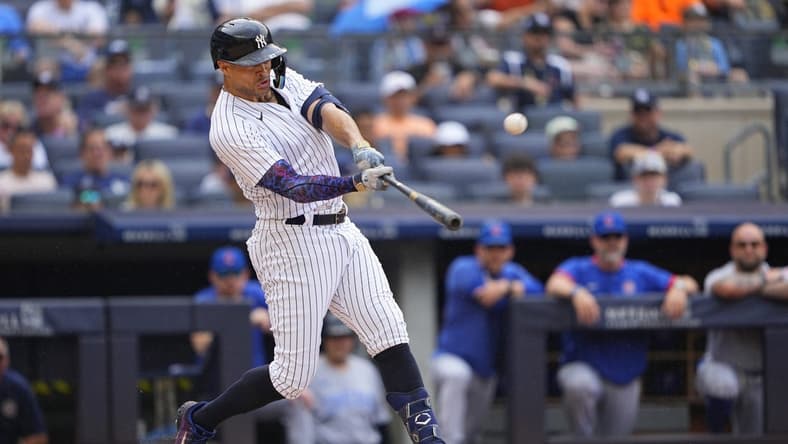 Jul 8, 2023; Bronx, New York, USA; New York Yankees right fielder Giancarlo Stanton (27) hits a home run against the Chicago Cubs during the first inning at Yankee Stadium. Mandatory Credit: Gregory Fisher-USA TODAY Sports
