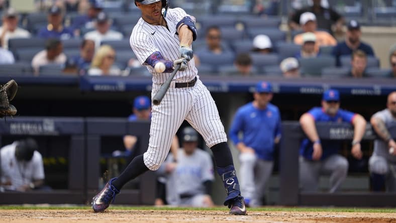 Jul 8, 2023; Bronx, New York, USA; New York Yankees right fielder Giancarlo Stanton (27) hits a two-run homer to right field against the Chicago Cubs during the fifth inning at Yankee Stadium. Mandatory Credit: Gregory Fisher-USA TODAY Sports