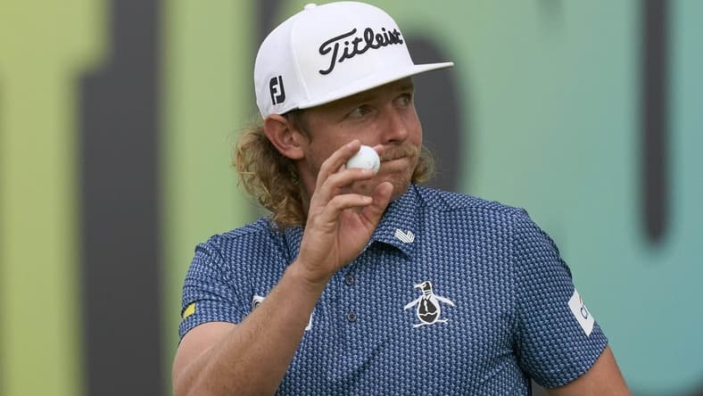 Jul 8, 2023; Hertfordshire, England, GBR; Cameron Smith (AUS) acknowledges the crowd on the 18th green during the second round of the LIV Golf London golf tournament at Centurion Club. Mandatory Credit: Peter van den Berg-USA TODAY Sports