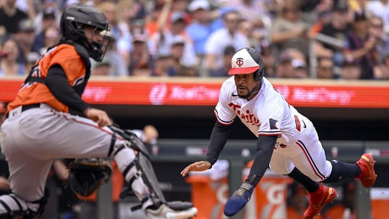 Jul 8, 2023; Minneapolis, Minnesota, USA; Minnesota Twins designated hitter Byron Buxton (25) dives for the plate and scores a run against the Baltimore Orioles during the sixth inning at Target Field. Mandatory Credit: Nick Wosika-USA TODAY Sports