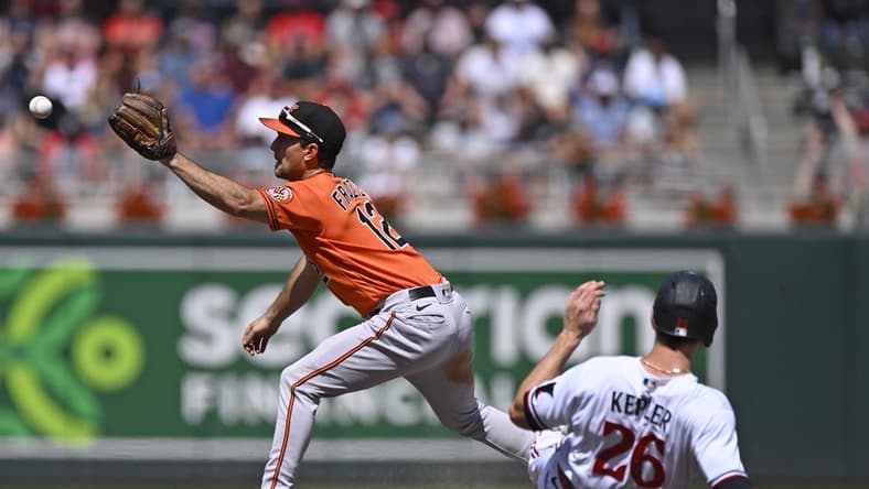 Jul 8, 2023; Minneapolis, Minnesota, USA; Baltimore Orioles infielder Adam Frazier (12) catches a ball to force out Minnesota Twins outfielder Max Kepler (26) during the eighth inning at Target Field. Mandatory Credit: Nick Wosika-USA TODAY Sports