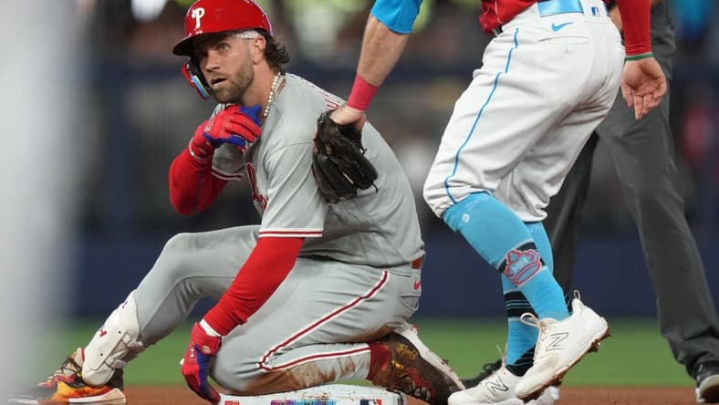 Jul 8, 2023; Miami, Florida, USA; Philadelphia Phillies designated hitter Bryce Harper (3) takes a moment after hitting a double in the second inning against the Miami Marlins at loanDepot Park. Mandatory Credit: Jim Rassol-USA TODAY Sports