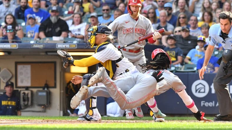 Jul 8, 2023; Milwaukee, Wisconsin, USA; Cincinnati Reds shortstop Elly De La Cruz (44) slides safely into home ahead of the tag by Milwaukee Brewers catcher William Contreras (24) in the seventh inning at American Family Field. Mandatory Credit: Michael McLoone-USA TODAY Sports