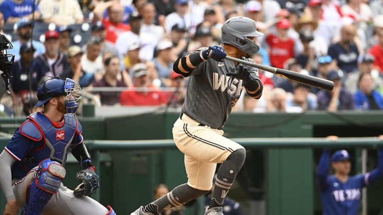 Jul 8, 2023; Washington, District of Columbia, USA; Washington Nationals third baseman Ildemaro Vargas (14) singles against the Texas Rangers during the fifth inning at Nationals Park. Mandatory Credit: Brad Mills-USA TODAY Sports