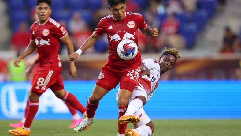 Jul 8, 2023; Harrison, New Jersey, USA; New York Red Bulls midfielder Omir Fernandez (21) battles for the ball against New England Revolution forward Latif Blessing (19) during the first half at Red Bull Arena. Mandatory Credit: Vincent Carchietta-USA TODAY Sports
