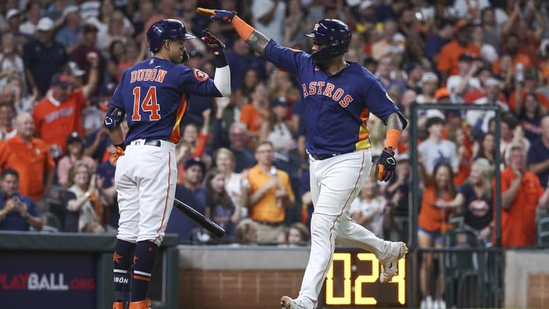 Jul 8, 2023; Houston, Texas, USA; Houston Astros catcher Martin Maldonado (15) celebrates with second baseman Mauricio Dubon (14) after hitting a home run during the eighth inning against the Seattle Mariners at Minute Maid Park. Mandatory Credit: Troy Taormina-USA TODAY Sports