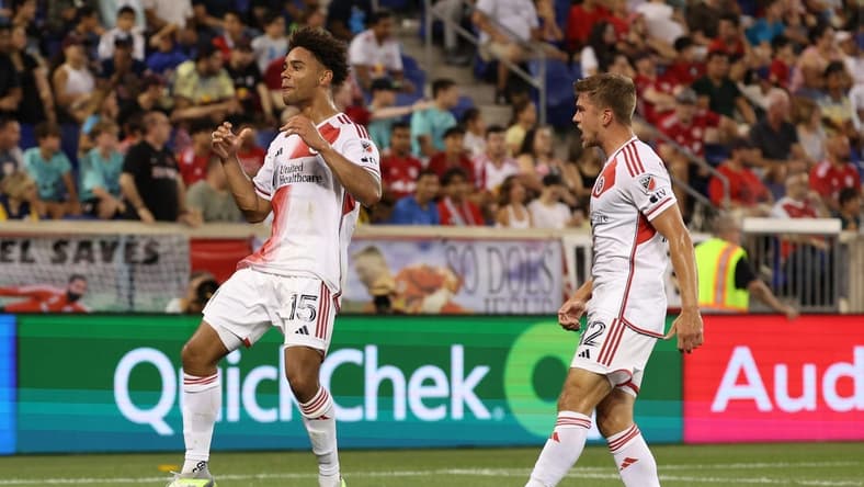 Jul 8, 2023; Harrison, New Jersey, USA; New England Revolution midfielder Brandon Bye (15) celebrates his goal with teammate New England Revolution forward Justin Rennicks (12) during the second half at Red Bull Arena. Mandatory Credit: Vincent Carchietta-USA TODAY Sports