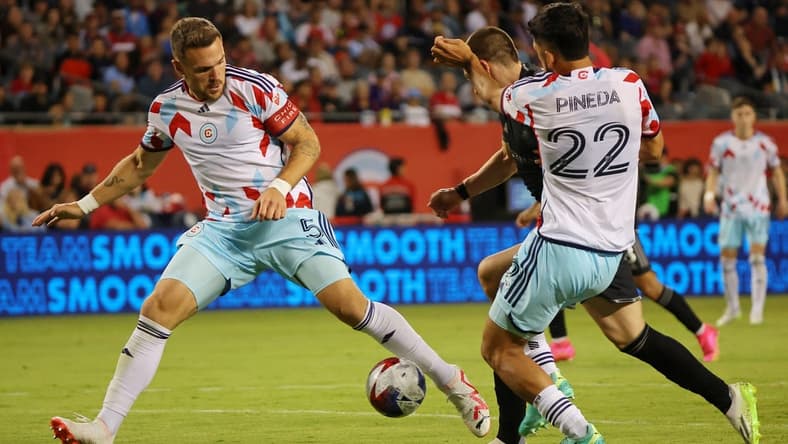 Jul 8, 2023; Chicago, Illinois, USA; Chicago Fire defender Rafael Czichos (5) and defender Mauricio Pineda (22) defend Nashville SC midfielder Alex Muyl (19) during the second half at Soldier Field. Mandatory Credit: Jon Durr-USA TODAY Sports