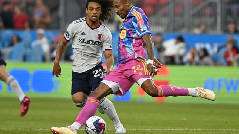 Jul 8, 2023; Toronto, Ontario, CAN;  Toronto FC midfielder Mark-Anthony Kaye (14) shoots the ball past St. Louis City midfielder Aziel Jackson (25) in the first half at BMO Field. Mandatory Credit: Dan Hamilton-USA TODAY Sports