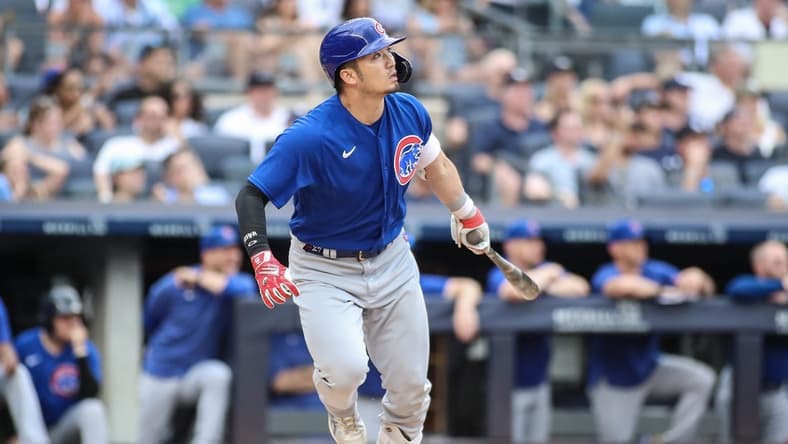Jul 9, 2023; Bronx, New York, USA; Chicago Cubs right fielder Seiya Suzuki (27) hits a go ahead RBI sacrifice fly in the eighth inning against the New York Yankees at Yankee Stadium. Mandatory Credit: Wendell Cruz-USA TODAY Sports