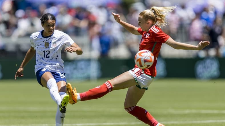 Jul 9, 2023; San Jose, California, USA; United States of America defender Alana Cook (12) passes past Wales midfielder Ceri Holland (7) during the first half at PayPal Park. Mandatory Credit: John Hefti-USA TODAY Sports